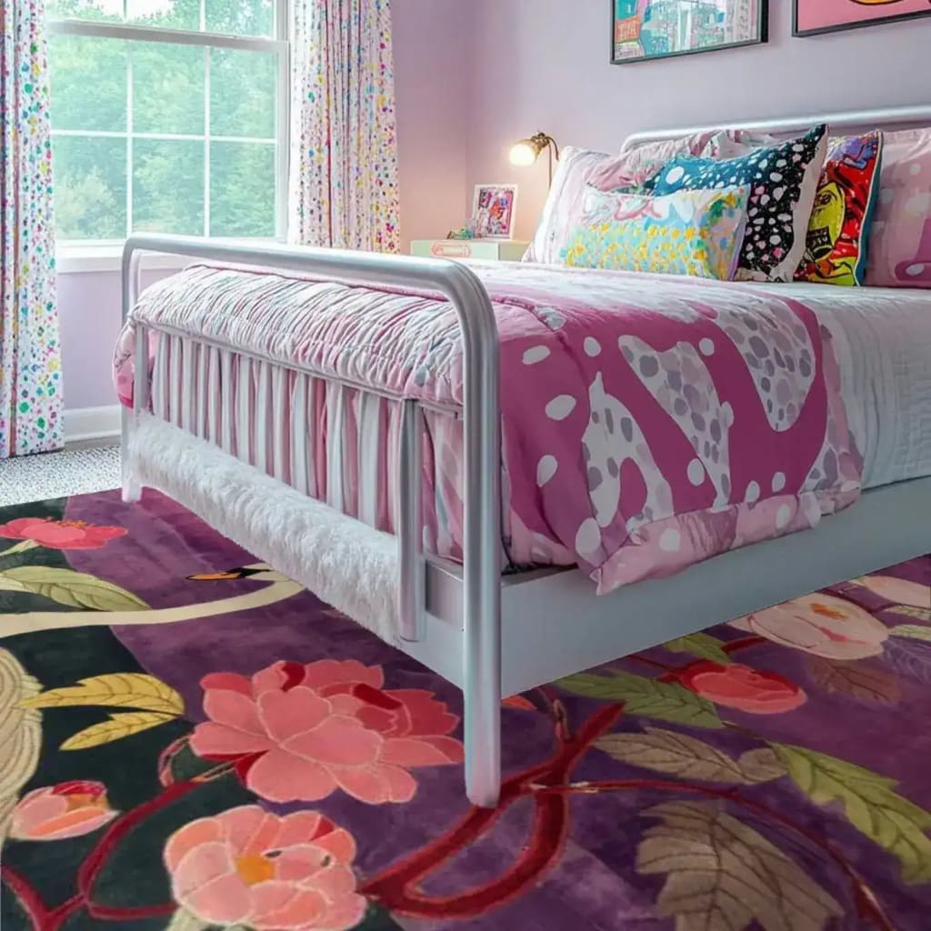 A vibrant wool area rug with floral patterns adds a splash of color to a cozy bedroom setting. The rug, perfect for dining room carpets, complements the room's playful decor with its intricate design and lush texture.