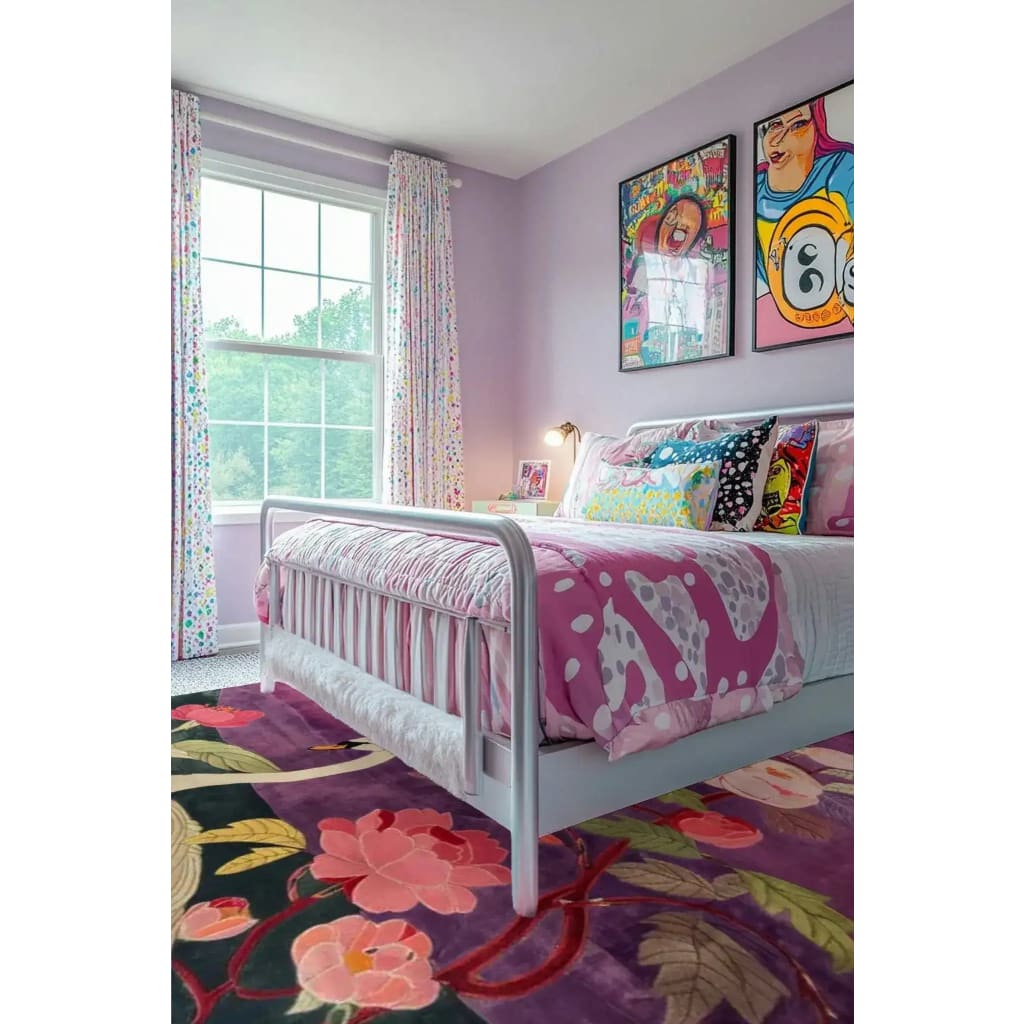 A vibrant Swan Serenity Wool Hand Knotted Area Rug featuring a floral design, placed in a colorful bedroom. The rug adds a splash of color with its intricate pattern, complementing the playful decor and bright atmosphere. Perfect for dining room carpets, this wool rug enhances any room with its artistic flair.