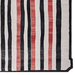 Top view of a contemporary area rug featuring bold vertical stripes in black, white, and red. This wool rug is perfect for adding a modern touch to living room spaces, available in 8x10 size. Ideal for those looking for stylish rugs for living room.