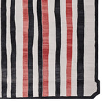 Top view of a contemporary area rug featuring bold vertical stripes in black, white, and red. This wool rug is perfect for adding a modern touch to living room spaces, available in 8x10 size. Ideal for those looking for stylish rugs for living room.