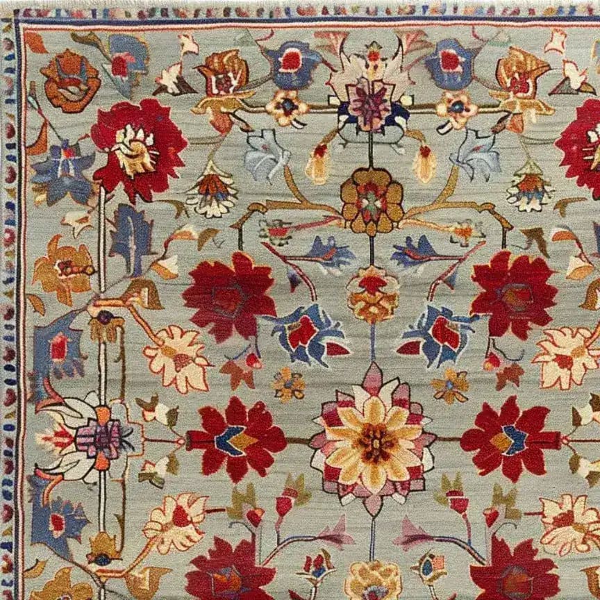 A detailed view of a symmetrical hand tufted area rug, perfect for large living rooms. This wool rug features a vibrant floral design with vintage charm, ideal for adding elegance to any living room space.