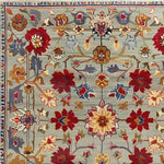A detailed view of a symmetrical hand tufted area rug, perfect for large living rooms. This wool rug features a vibrant floral design with vintage charm, ideal for adding elegance to any living room space.