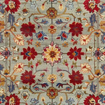 This vibrant Symmetrical Hand Tufted Rug features an intricate floral design in rich reds, blues, and golds, perfect for adding a vintage touch to large living rooms. Made from high-quality wool, this area rug is both durable and stylish, ideal for enhancing your living room decor with an elegant, vintage-inspired look.