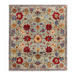 This beautiful symmetrical hand tufted area rug features an intricate floral design with vibrant reds, yellows, and blues on a soft gray background. Perfect for adding a vintage touch to large living rooms, this wool rug combines elegance and comfort, making it an excellent choice for area rugs for the living room.