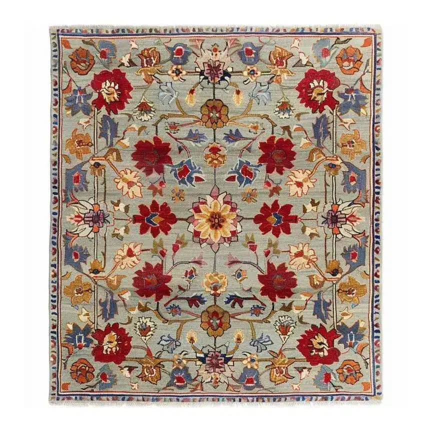 This beautiful symmetrical hand tufted area rug features an intricate floral design with vibrant reds, yellows, and blues on a soft gray background. Perfect for adding a vintage touch to large living rooms, this wool rug combines elegance and comfort, making it an excellent choice for area rugs for the living room.