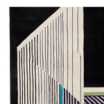 Close-up view of the 'Symmetry in Motion' hand-tufted wool area rug, showcasing a contemporary design with bold black and cream stripes, perfect for modern living room spaces.