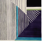 This contemporary hand-tufted wool rug features a striking geometric pattern with bold lines and vibrant colors, perfect for enhancing any living room space. The area rug showcases a modern design that combines dark and light shades, making it an ideal choice for those seeking stylish living room area rugs.