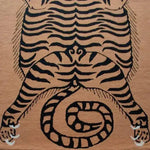 A unique tanned jungle cat design on a hand-tufted wool area rug. This stylish area rug features bold black stripes on a warm tan background, perfect for adding a touch of the wild to your living room or bedroom. Ideal for those seeking distinctive living room rugs in an 8x10 size or elegant rugs for the bedroom.