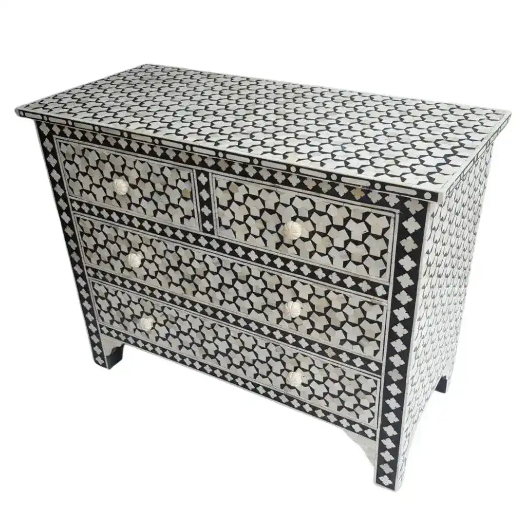 Targua bone inlay chest of 4 drawers, black ground with white star and quatrefoil mosaic pattern, brass circular knob pulls