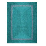 Top view of a teal and gray braided jute area rug, perfect for enhancing your living room decor. This living room area rug features a simple yet elegant design with a central teal panel bordered by a subtle gray accent.
