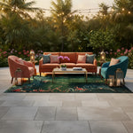 Teal rug with coral floral accents anchoring an outdoor patio lounge with tropical greenery