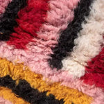 Close-up of The Altas Pink Boujaad Wool Rug Runner showcasing its vibrant colors and thick, plush texture. Perfect for use as a living room area rug, kitchen rug, or bathroom runner rug, this wool rug adds warmth and style to any hallway or office space.