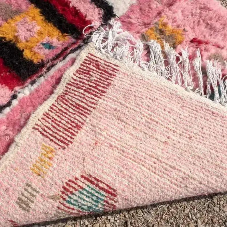 Close-up of the Altas Pink Boujaad wool rug runner, showcasing its vibrant pink hues with intricate patterns ideal for living room area rugs, kitchen rugs, and hallway runner rugs. This wool rug features a blend of geometric designs, perfect for adding warmth and style to any space like a living room or office.