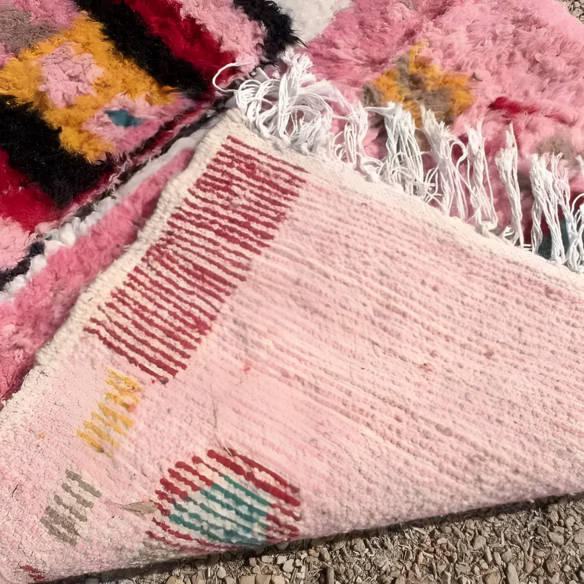 Close-up of the Altas Pink Boujaad wool rug runner, showcasing its vibrant pink hues with intricate patterns ideal for living room area rugs, kitchen rugs, and hallway runner rugs. This wool rug features a blend of geometric designs, perfect for adding warmth and style to any space like a living room or office.