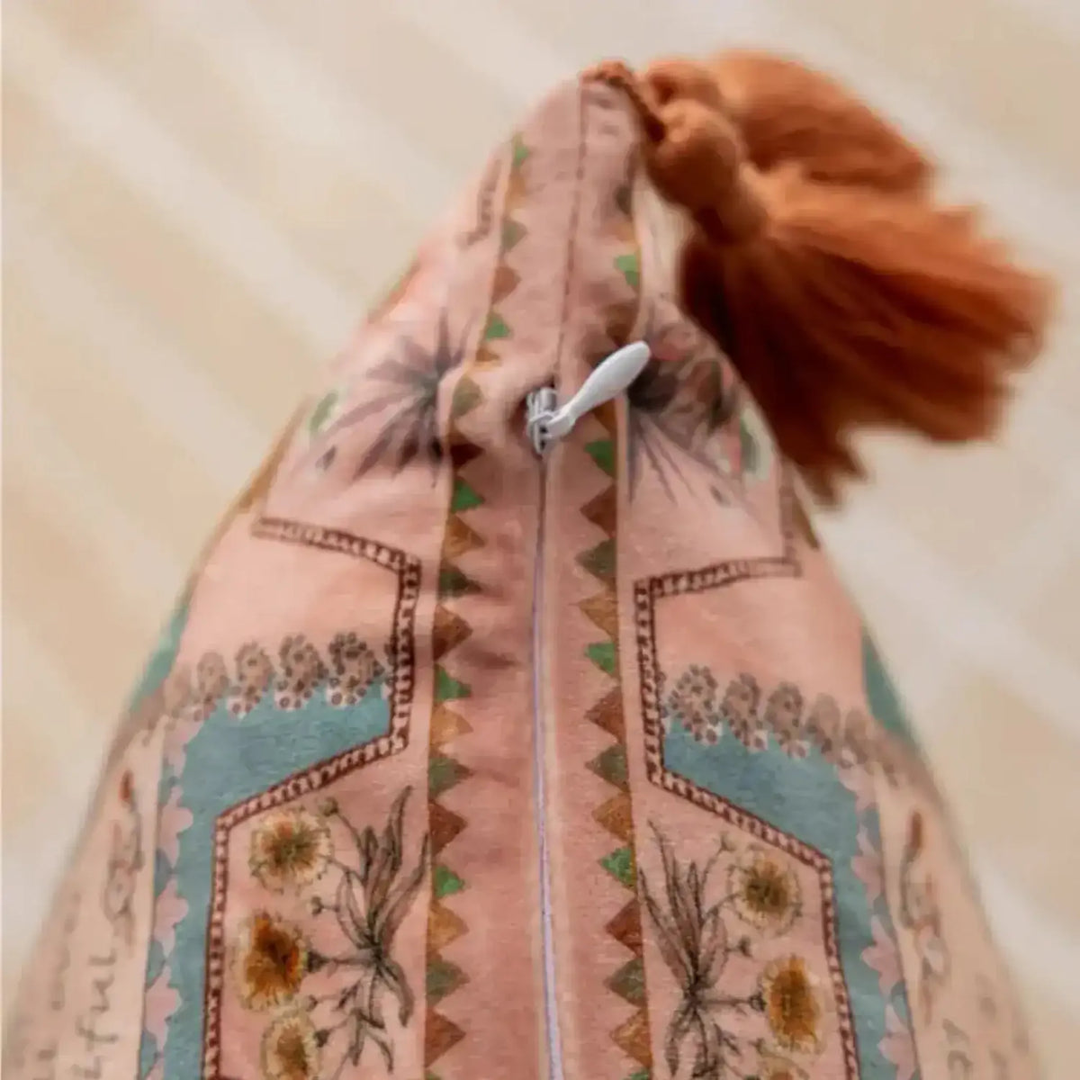 Close-up view of the zipper and tassel detail on the Asian Wild Velvet Throw Pillow Cover, showcasing its intricate patterns and vibrant colors.