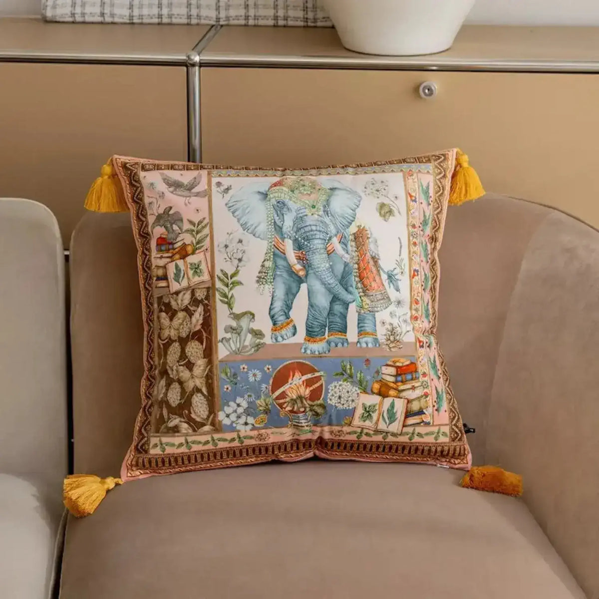 Decorative throw pillow featuring an illustrated elephant design with intricate patterns and tassels, perfect for adding a touch of elegance to any living space.