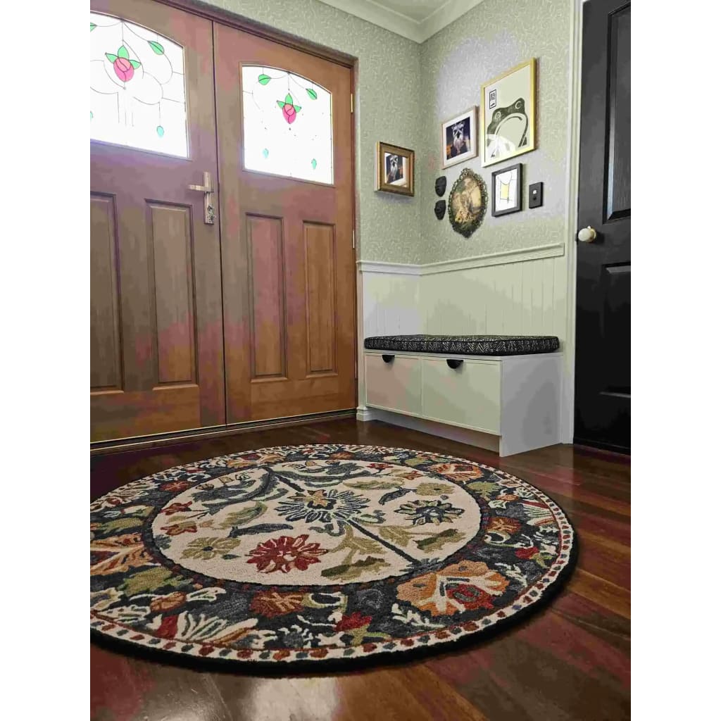 The Blossom Grace Hand Tufted Round Rug adds a touch of elegance to your dining room with its intricate floral patterns and rich colors. This wool area rug is perfect for both dining room carpets and living room settings, offering a warm and inviting feel.
