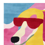 Vibrant area rug featuring a contemporary design of a stylized dog wearing sunglasses, perfect for adding a splash of color to your living room. This hand-tufted wool rug combines shades of yellow, pink, and blue for a playful yet modern look.