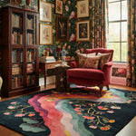 Cozy room with a red armchair, bookshelf, and floral wallpaper.