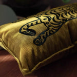 Elegant throw pillow featuring a majestic Bengal tiger design on a luxurious golden fabric, perfect for home decor and adding a touch of wildlife elegance to any space.