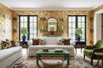 Living room with floral rug, white sofa, green coffee table, and decorative elements.