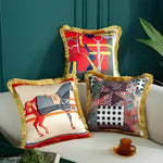 Decorative throw pillows featuring vibrant animal prints and fringe detailing, perfect for adding a touch of elegance to any living space.