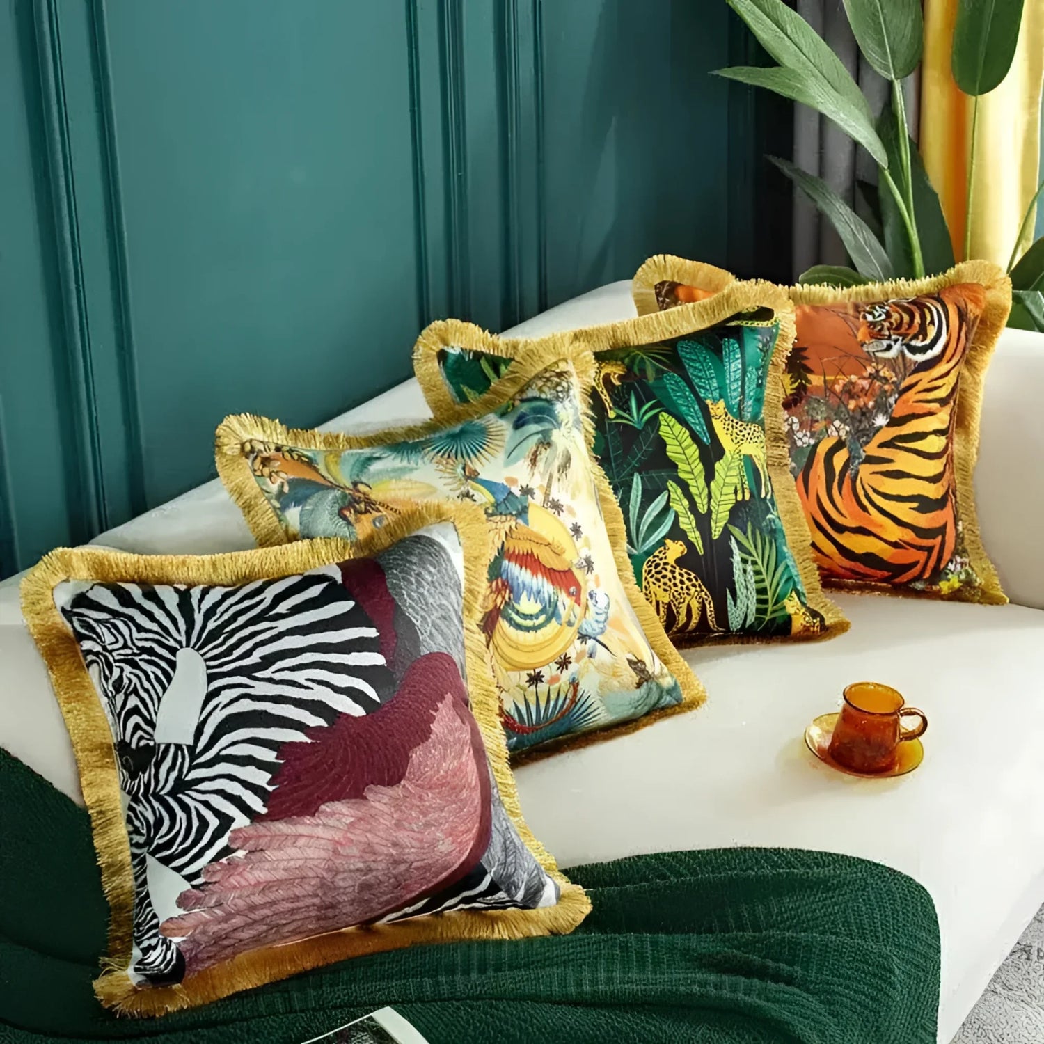 Vibrant throw pillows from The Royal Animal Collection featuring exotic animal prints and fringed edges, perfect for home decor.