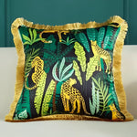 Vibrant throw pillow featuring a jungle animal print with leopards and lush green foliage, framed with a decorative fringe.
