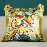 Colorful embroidered throw pillow featuring a vibrant bird design with intricate details and fringed edges, perfect for home decor.