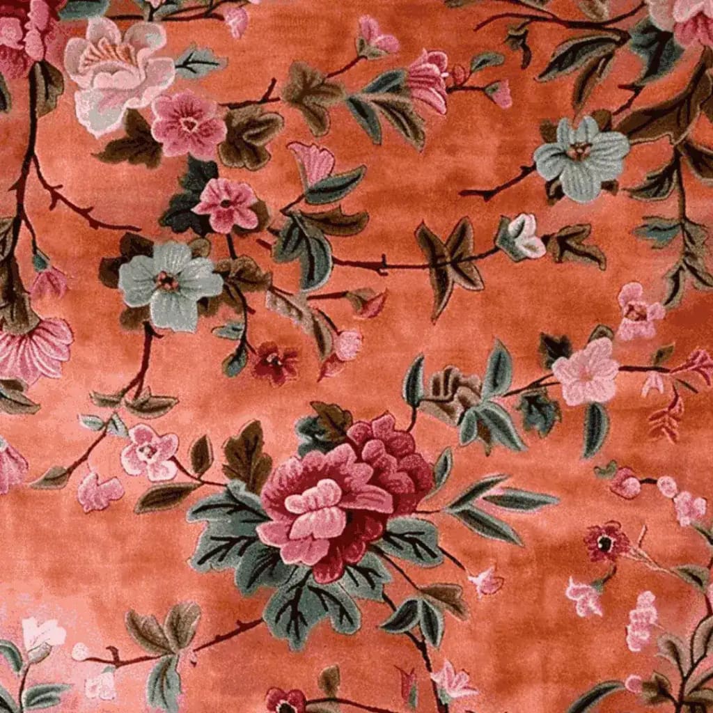 The Secret Garden Hand Knotted Rug features a vibrant floral design on a warm, orange background. This wool area rug, perfect for living room and dining room settings, adds a touch of elegance to formal dining spaces with its intricate floral patterns.