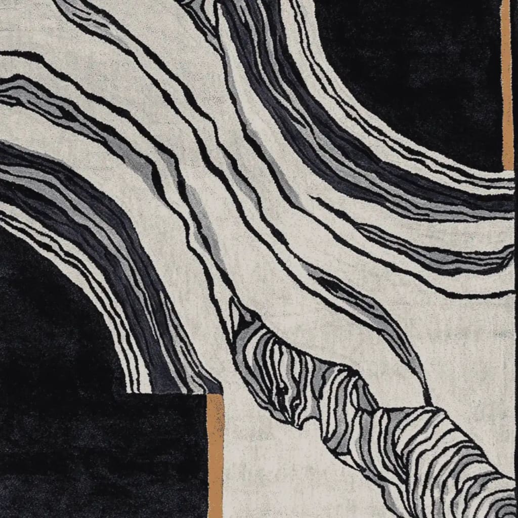 This image showcases 'The Space Between Hand Tufted Rug', a contemporary area rug perfect for large living rooms. The design features bold, abstract patterns in black, white, and gray, ideal for adding a modern touch to your space. Crafted from wool, this 8x10 rug combines style and durability.