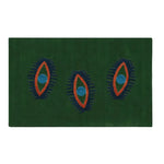 A vibrant green hand-tufted wool area rug featuring three abstract eye designs in blue and orange, perfect for adding a touch of vintage charm to any dining room or bedroom. Ideal as a dining table rug, kitchen runner rug, or hallway runner rug.