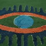 Close-up of a textured tufted wool rug with eye design pattern and blue center