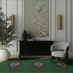 Modern interior with a green eye hand tufted rug, gray chair, black cabinet, and wall art.