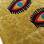 Stylish area rug featuring a bold design with three abstract eyes, perfect for adding a unique touch to living room and dining room spaces. This wool rug combines vibrant colors and a vintage flair, ideal for both casual and formal dining room settings.
