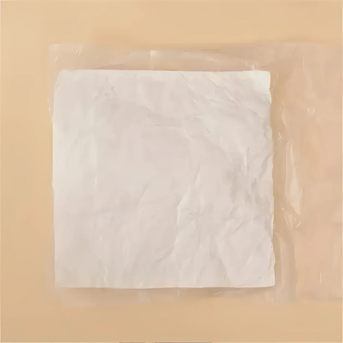 A package of throw pillow filling material, featuring crumpled white fibers wrapped in plastic, ideal for DIY pillow projects.