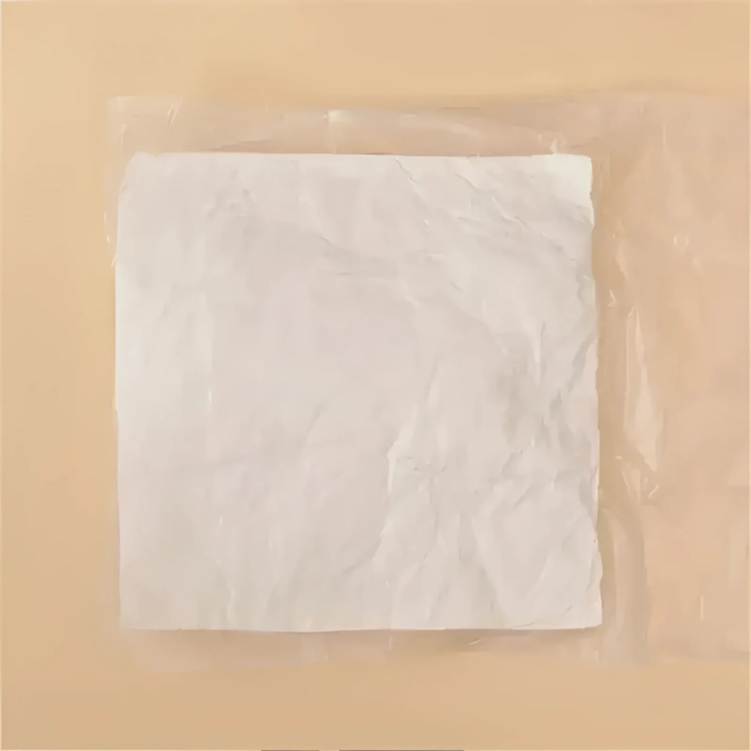 A package of throw pillow filling material, featuring crumpled white fibers wrapped in plastic, ideal for DIY pillow projects.