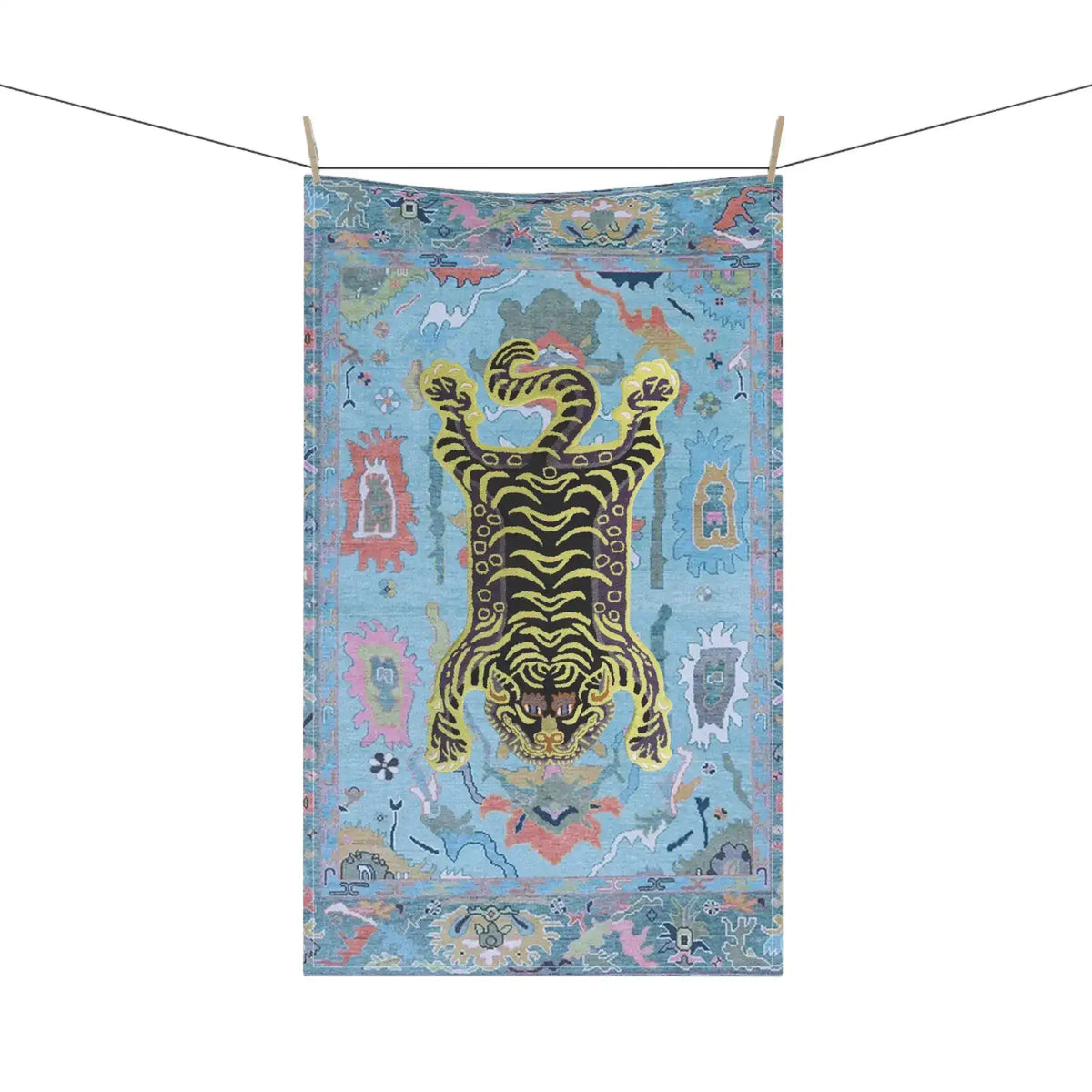 Tibetan tiger kitchen towel hanging on clothesline, blue printed cotton with yellow-black tiger and colorful decorative border