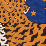 Close-up view of a Tibetan Tiger Starry Night Scallop Hand Tufted Wool Rug featuring bold orange and black tiger patterns with a rich blue starry backdrop. This vibrant wool rug is perfect for adding a touch of vintage charm to large living rooms, or as a statement piece in kitchens and hallways.