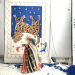 A skilled artisan hand tufting a Tibetan Tiger Starry Night Scallop Wool Rug. The area rug features a vivid depiction of a tiger and celestial motifs, perfect for large living rooms or as a vintage hallway runner rug. This wool rug combines traditional craftsmanship with a unique design, suitable for kitchen runner rugs or as a statement piece in an 8x10 living room setting.