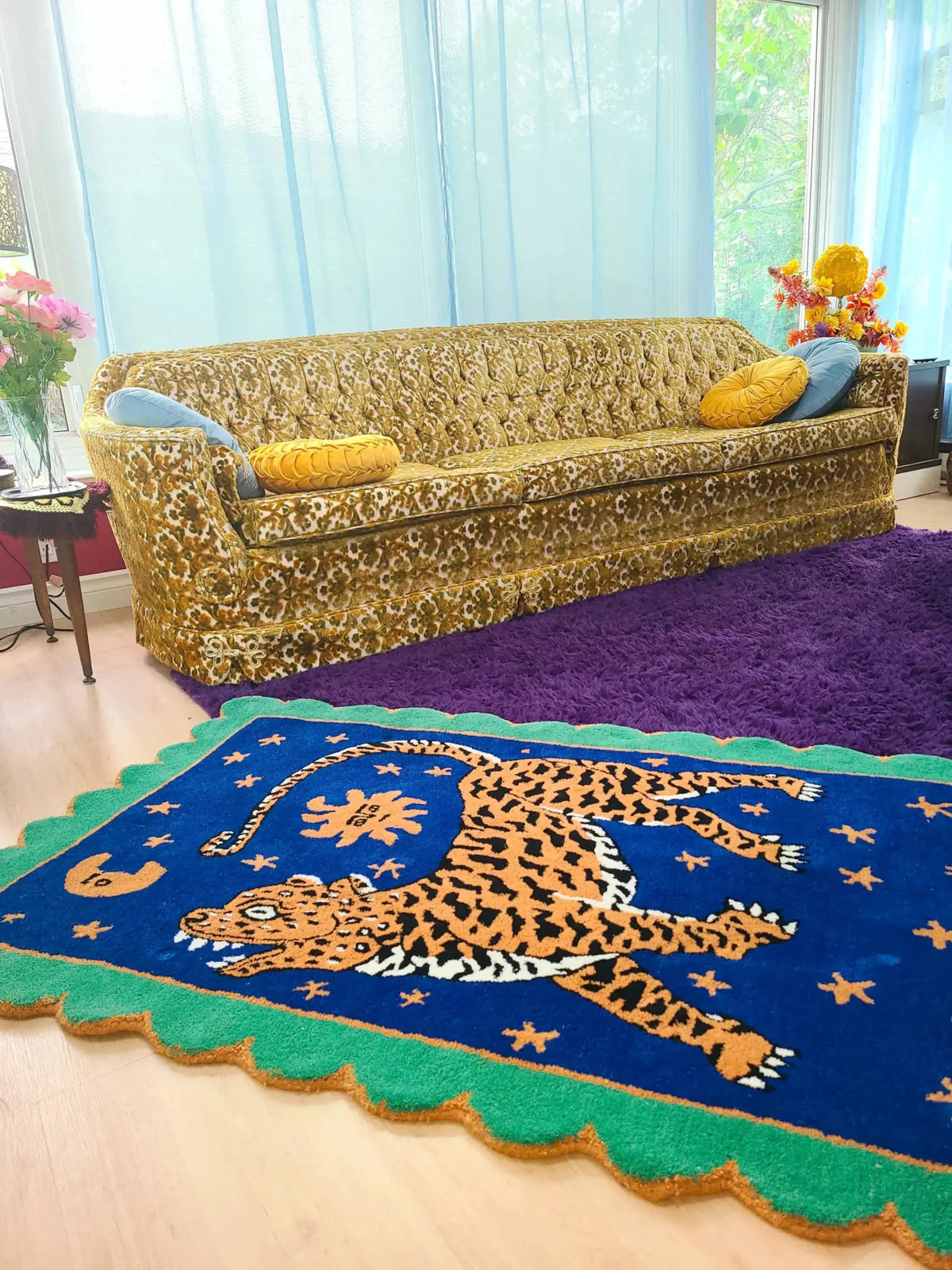 A vibrant Tibetan Tiger Starry Night Scallop Hand Tufted Wool Rug placed in a cozy living room. The area rug features a striking tiger design in rich colors, perfect for large living room rugs or as a vintage rug accent. The plush wool rug complements the eclectic decor, adding warmth and texture to the space. Ideal for use as kitchen rugs, bathroom runner rugs, or hallway runner rugs, this versatile piece fits perfectly in living room rugs 8x10 settings.