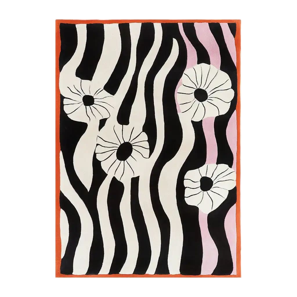 A contemporary area rug featuring bold black and white wavy stripes with abstract floral designs. This hand-tufted wool rug, perfect for a modern living room, measures 8x10 and adds a stylish touch with its vibrant pattern.