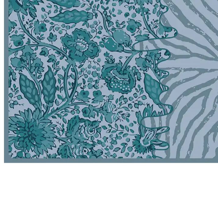 Close-up view of the Tidal Serenade Hand Tufted Wool Rug, showcasing intricate floral patterns in shades of teal and blue. This area rug is perfect for enhancing any living room, ideal for those seeking living room rugs in 8x10 size, crafted from high-quality wool.