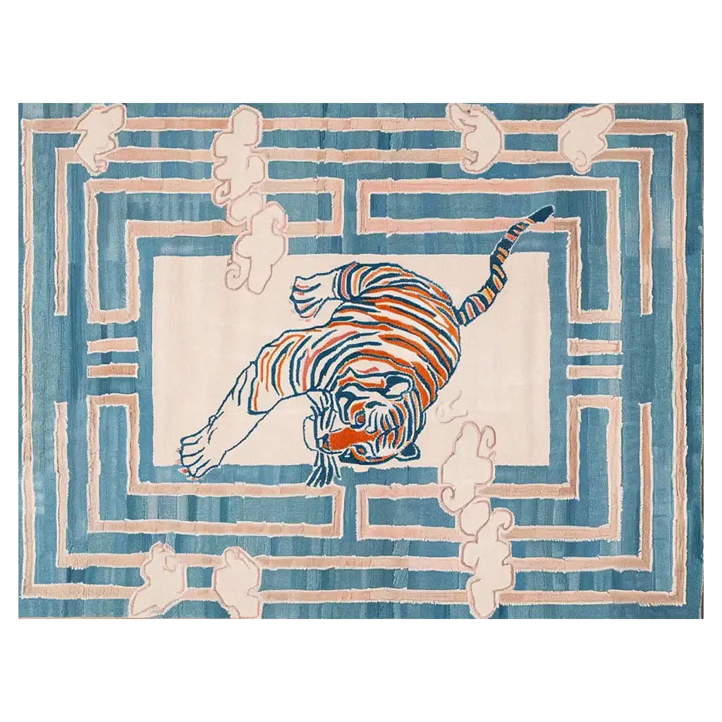 Vibrant Tiger Blossom Canopy Hand Tufted Wool Rug showcasing an abstract tiger design in blue and orange hues. This large living room area rug offers a striking visual with its intricate pattern, perfect for adding a bold touch to any space.