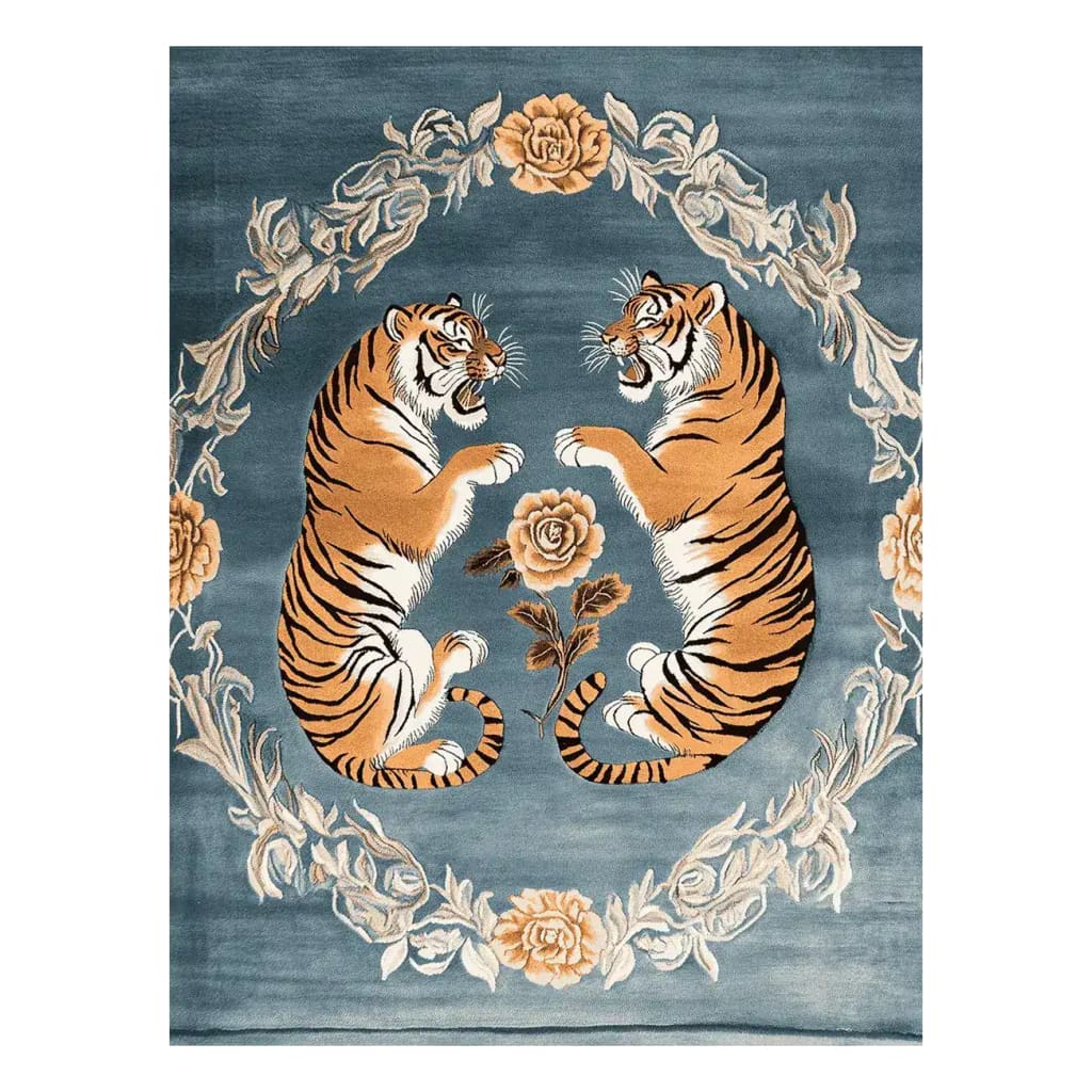 The Tiger's Grace Hand Tufted Rug features an exquisite design with two majestic tigers surrounded by floral patterns on a rich blue background. This wool area rug is perfect for large living rooms, offering a vintage touch with its detailed and elegant floral motifs, ideal as an area rug for living room decor.