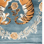 This beautiful hand tufted area rug features an elegant tiger design intertwined with floral patterns on a soft blue background, perfect for large living rooms. Made from high-quality wool, it combines the timeless appeal of vintage rugs with a modern touch, making it an ideal area rug for your living room.