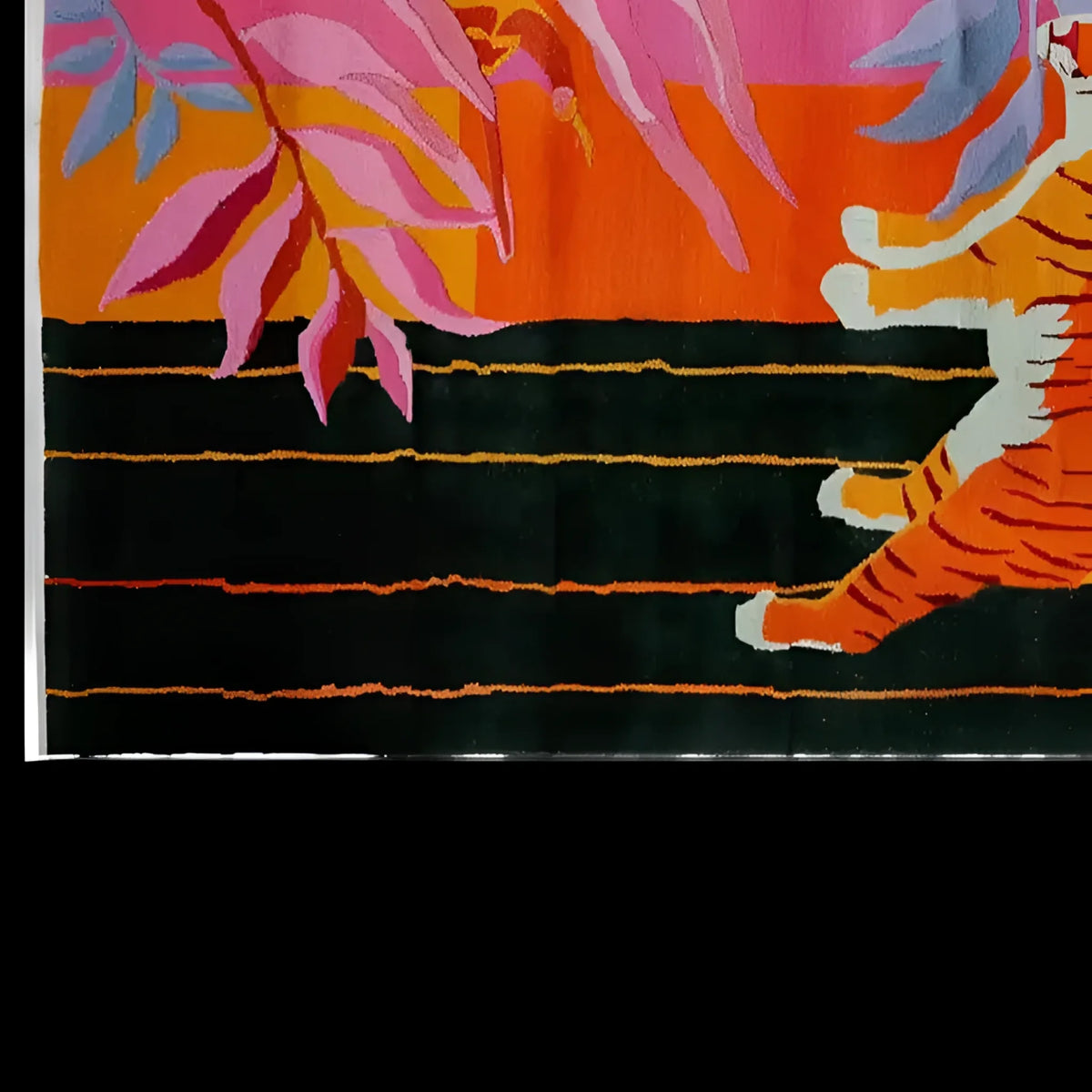 Top view of a vibrant and colorful wool area rug featuring an abstract tiger design with bold pink, orange, and black patterns.