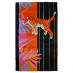 Colorful abstract tiger design on a hand-tufted wool area rug, featuring vibrant orange, pink, and black hues.