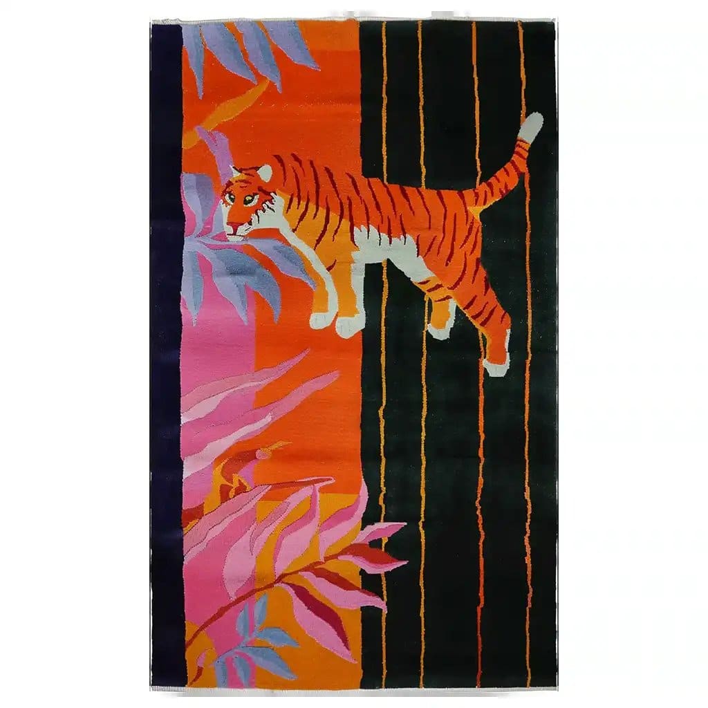 Colorful abstract tiger design on a hand-tufted wool area rug, featuring vibrant orange, pink, and black hues.
