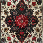 A beautifully detailed Timeless Floral Medley hand-knotted wool rug featuring an intricate floral pattern in rich red, black, and cream tones. This Persian-inspired vintage rug is perfect for enhancing the elegance of any living room or office space. Ideal as an 8x10 area rug, it brings a touch of warmth and sophistication to your decor.